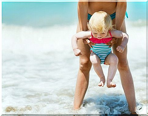 First bath in the sea of ​​a baby