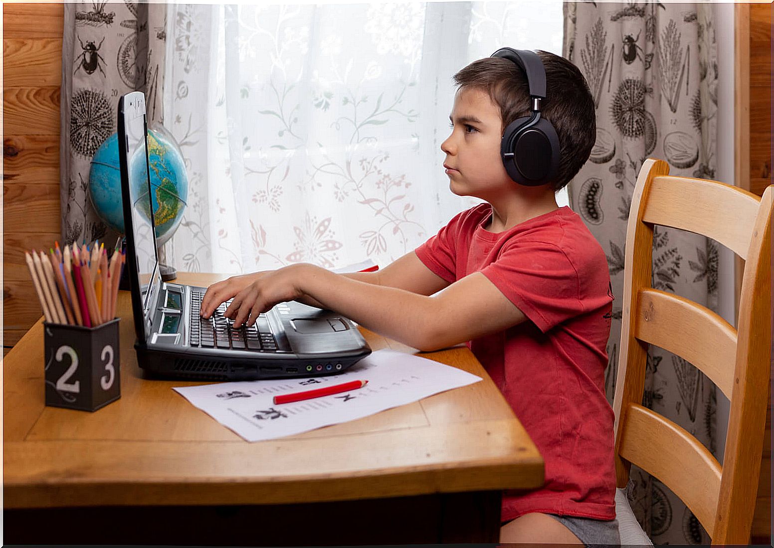 Child with computer learning typing.