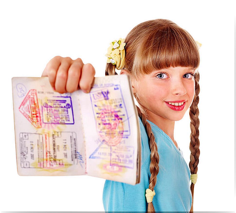 Girl showing her passport stamps.