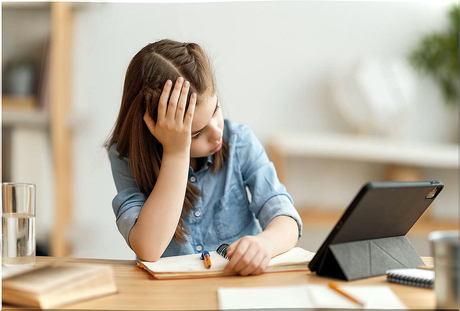 Girl doing homework frustrated by her excessive perfectionism.