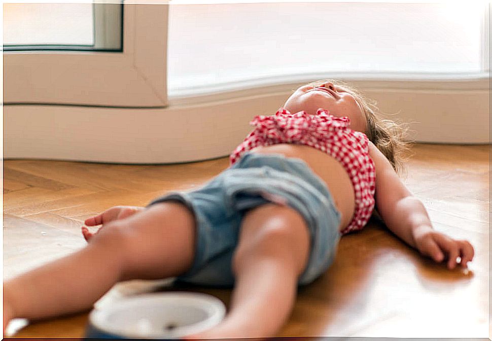 Girl crying on the floor due to Disruptive Mood Dysregulation Disorder.