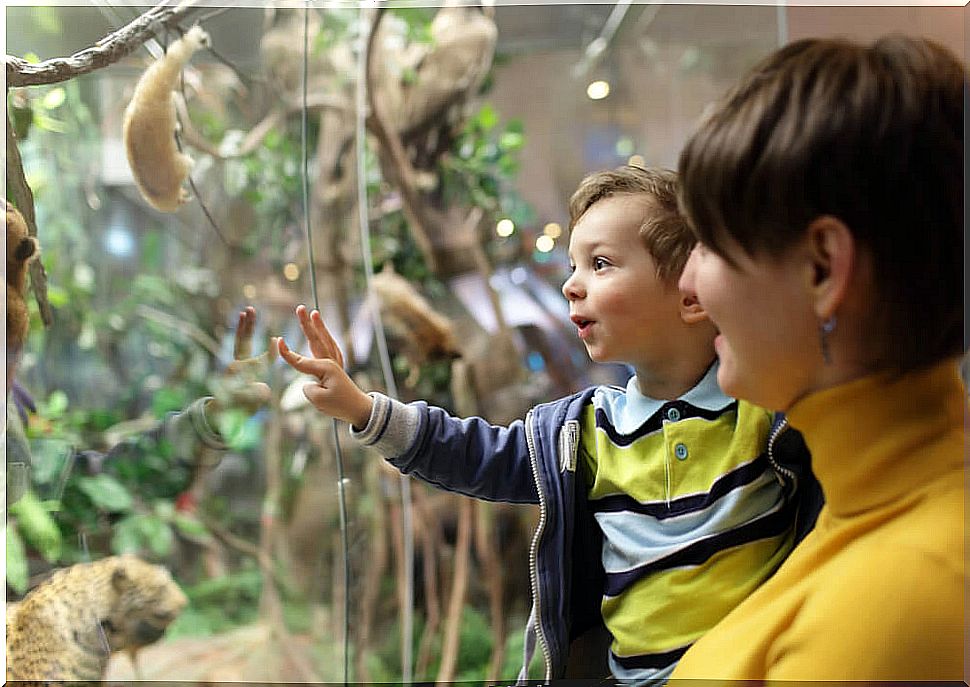Boy with his mother visiting a museum to remember that he was present.
