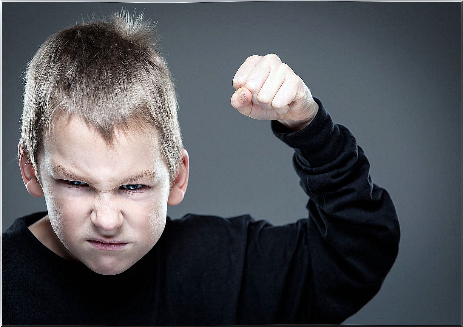 Child with raised fist ready to hit due to negative modeling at home.