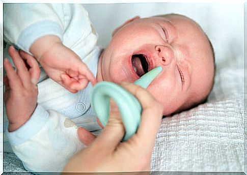 Baby with respiratory syncytial virus trying to clear the nostrils.