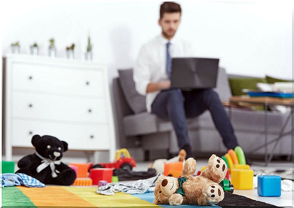 Man meeting the challenge of taking care of children and working from home.