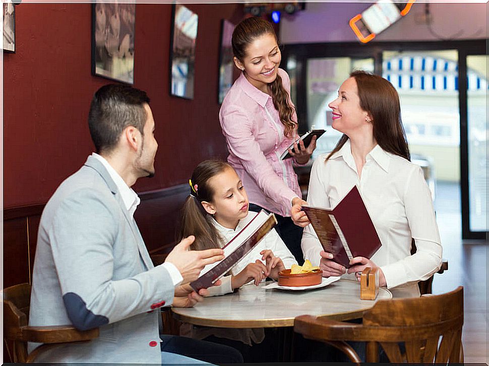 parents with their daughter in a restaurant