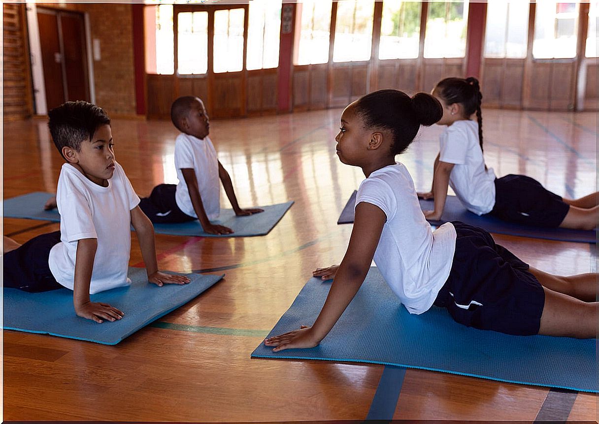 Children practicing the upward facing dog pose.